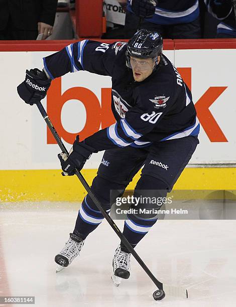 Nik Antropov of the Winnipeg Jets looks to pass the puck in a game against the Pittsburgh Penguins on January 25, 2013 at the MTS Centre in Winnipeg,...