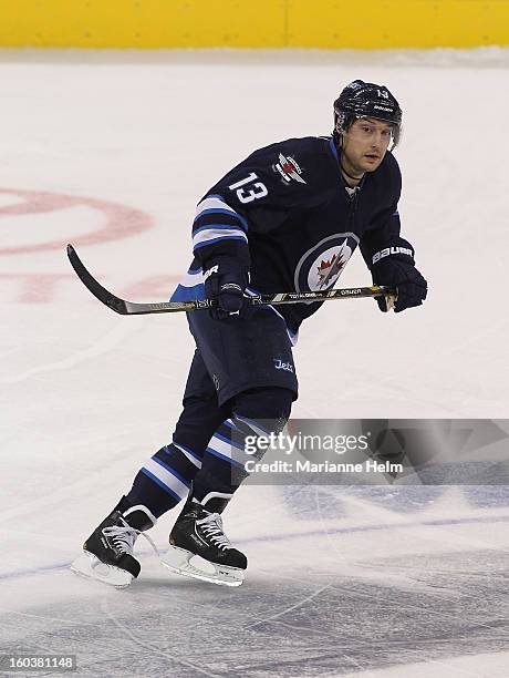 Kyle Wellwood of the Winnipeg Jets skates down the ice during a game against the Pittsburgh Penguins on January 25, 2013 at the MTS Centre in...