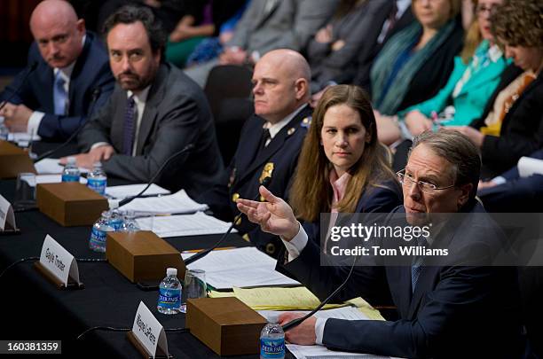 Wayne LaPierre, right, executive vice president and CEO of the National Rifle Association, testifies before a Senate Judiciary Committee hearing in...