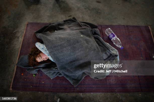 Girl sleeps as new Syrian refugees arrive at the International Organization for Migration at the Za’atari refugee camp on January 30, 2013 in Mafrq,...
