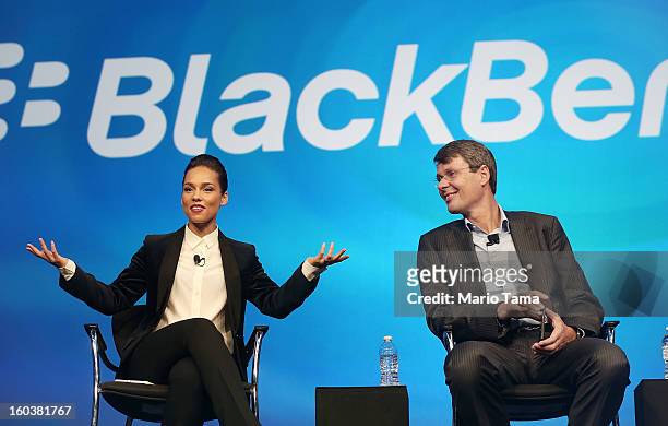 BlackBerry President and Chief Executive Officer Thorsten Heins looks on as new BlackBerry Global Creative Director Alicia Keys speaks at the...