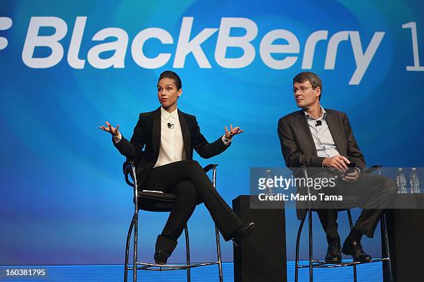 BlackBerry President and Chief Executive Officer Thorsten Heins looks on as new BlackBerry Global Creative Director Alicia Keys speaks at the...