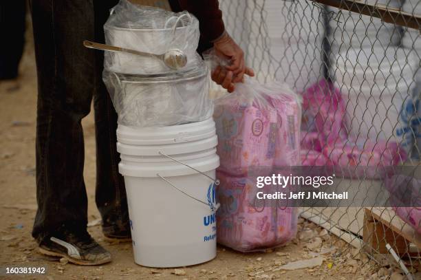 Refugees from Syria collect food and supplies from the UNHCR as they arrive at the Za’atari refugee camp on January 30, 2013 in Mafrq, Jordan. Record...