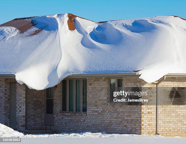 house engulfed with heavy blizzard snows - damaged roof stock pictures, royalty-free photos & images