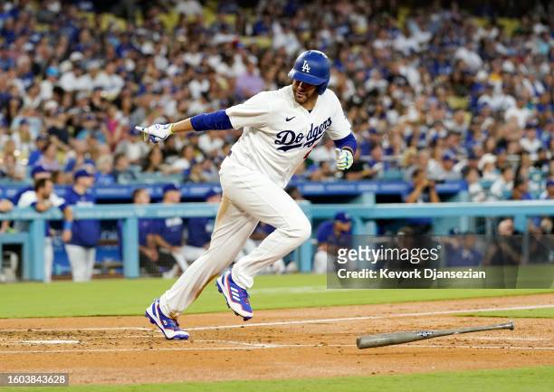 Martinez of the Los Angeles Dodgers runs to first base after reaching on interference by catcher William Contreras of the Milwaukee Brewers, scoring...