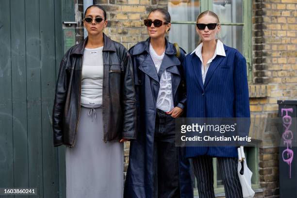 Hanna MW wears black leather jacket, grey skirt, white shirt & Darja Barannik wears navy coat, Loewe knit & Tine Andrea wears blue striped oversized...