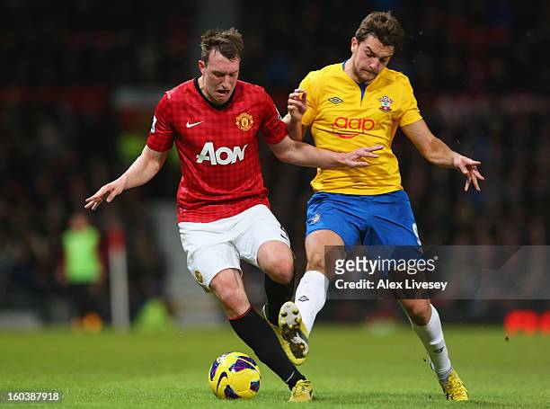 Phil Jones of Manchester United is challenged by Jay Rodriguez of Southampton during the Barclays Premier League match between Manchester United and...