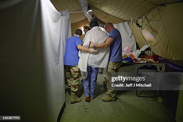 Victim of the conflict in Syria is helped at A French military hospital in the Za’atari refugee camp on January 30, 2013 in Za'atari, Jordan. Record...