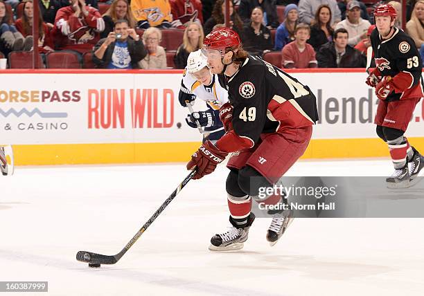 Alexandre Bolduc of the Phoenix Coyotes skates the puck up ice against the Nashville Predators at Jobing.com Arena on January 28, 2013 in Glendale,...