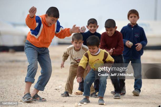 Syrian refugee children play in the Za’atari refugee camp on January 30, 2013 in Za'atari, Jordan. Record numbers of refugees are fleeing the...