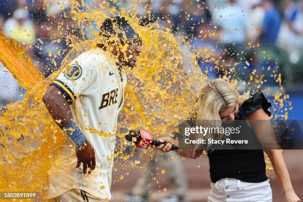 Andruw Monasterio of the Milwaukee Brewers is doused with Gatorade while being interviewed by Sophia Minnaert following a game against the Colorado...