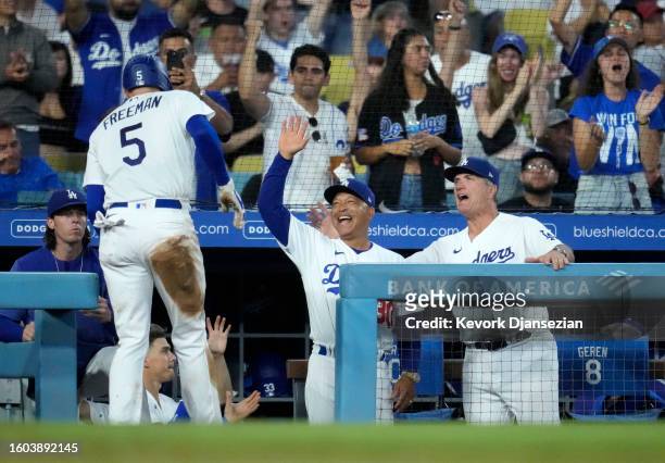 Manger Dave Roberts of the Los Angeles Dodgers celebrates Freddie Freeman scoring a run against Milwaukee Brewers in the sixth inning at Dodger...