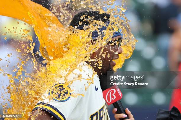 Andruw Monasterio of the Milwaukee Brewers is doused with Gatorade while being interviewed by Sophia Minnaert following a game against the Colorado...