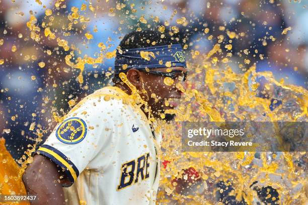 Andruw Monasterio of the Milwaukee Brewers is doused with Gatorade while being interviewed by Sophia Minnaert following a game against the Colorado...