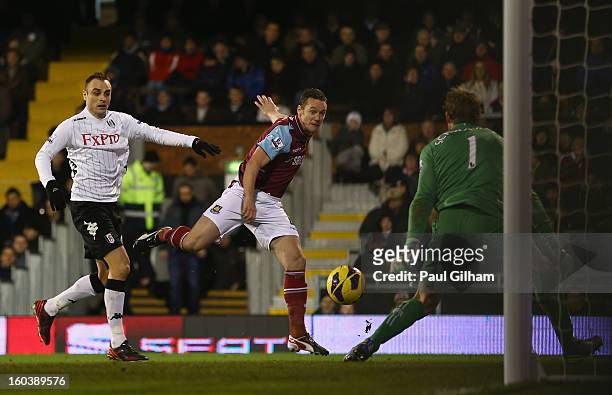 Kevin Nolan of West Ham United scores his side's first goal past Mark Schwarzer of Fulham during the Barclays Premier League match between Fulham and...