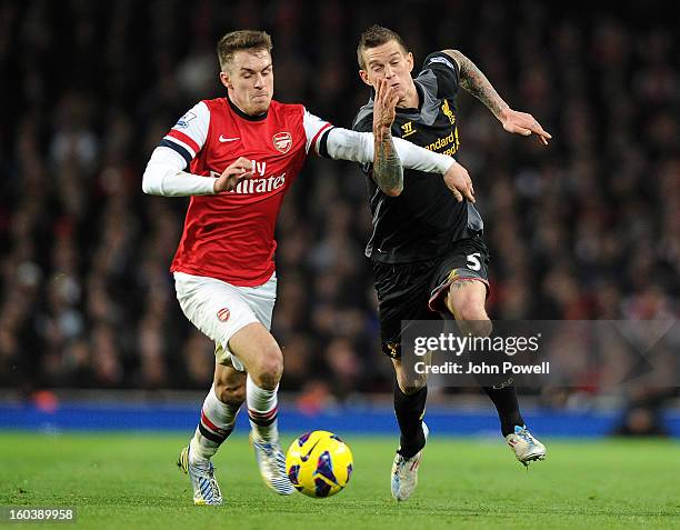 Daniel Agger of Liverpool competes with Aaron Ramsey of Arsenal during the Barclays Premier League match between Arsenal and Liverpool at Emirates...