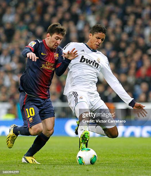 Raphael Verane of Real Madrid duels for the ball with Lionel Messi of Barcelona during the Copa del Rey Semi-Final first leg match between Real...
