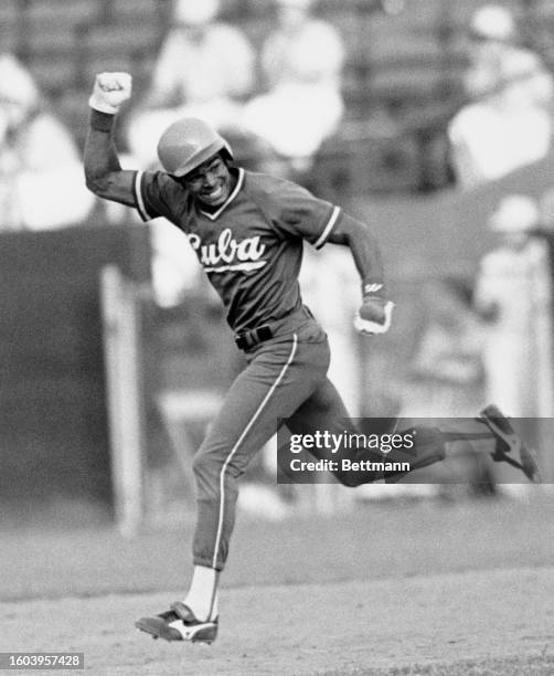 Jubilant Antonio Pacheco cheers as he runs after hitting a 9th inning home run, to rally Cuba to a 6-5 victory in the Pan American Games,...