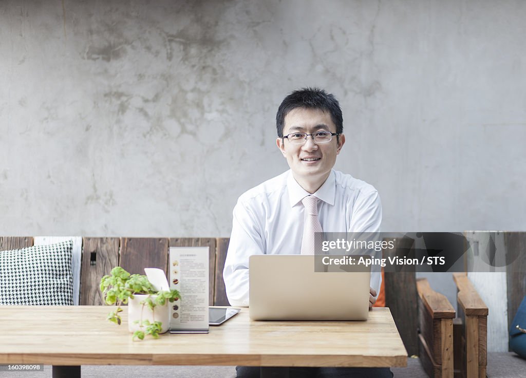 Businessman using laptop in a restaurant