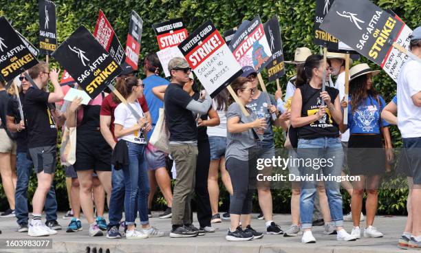 Members and supporters of SAG-AFTRA and WGA walk the picket line at Paramount Studios on August 09, 2023 in Los Angeles, California. Members of...