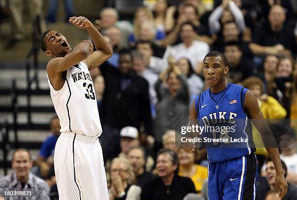 Aaron Rountree III of the Wake Forest Demon Deacons reacts after a play as Rasheed Sulaimon of the Duke Blue Devils walks down the court during their...