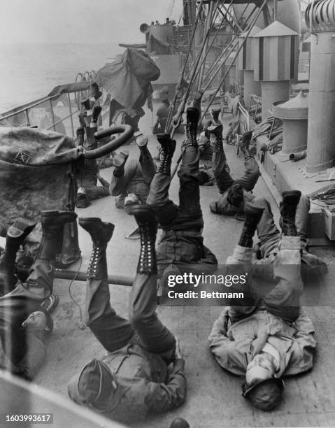 Soldiers exercise on deck as they set sail to the Aleutian Islands; At Sea, circa 1944.