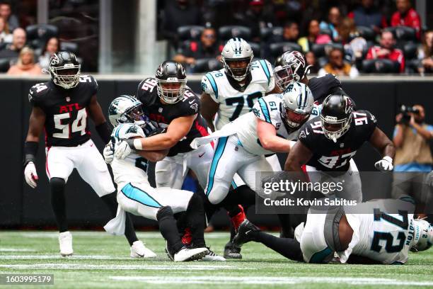 Tyeler Davison of the Atlanta Falcons tackles Ameer Abdullah of the Carolina Panthers during an NFL game at Mercedes-Benz Stadium on October 31, 2021...