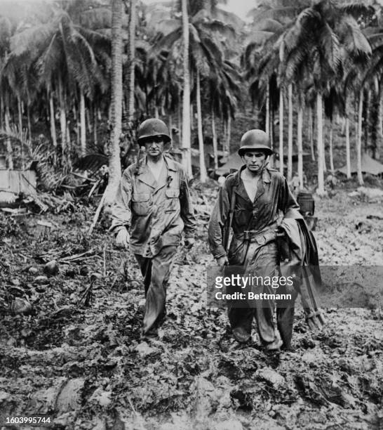 Gen. John H. Hester and Lt. Stanley W. Woodruff trek through muddy terrain on Rendova Island, Solomon Islands, 6th May 1944.
