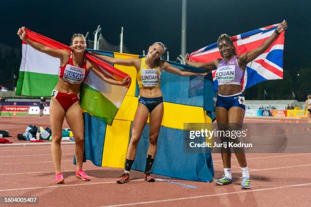 Nora Lindahl of Sweden, Succes Eduan of Great Britain and Alexa Sulyan of Hungary pose with flags afterWomen's 200m during European Athletics U20...