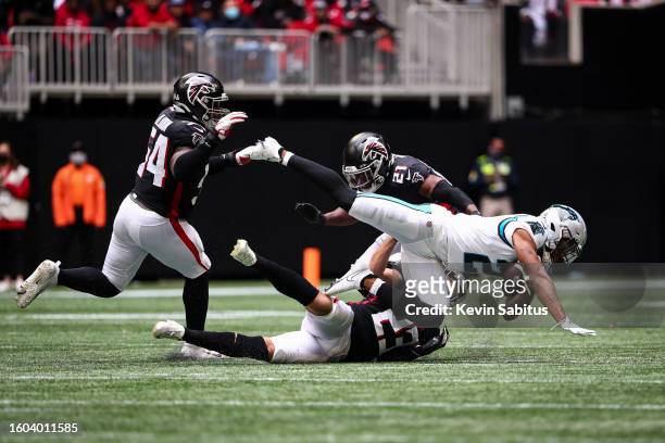 Erik Harris of the Atlanta Falcons tackles DJ Moore of the Carolina Panthers during an NFL game at Mercedes-Benz Stadium on October 31, 2021 in...