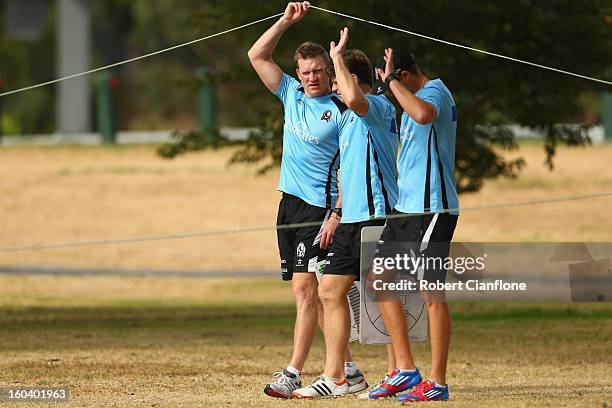 Magpies coach Nathan Buckley arrives with assistant coaches Robert Harvey and Matthew Lappin prior to a Collingwood Magpies training session at...