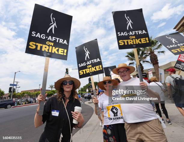 Michelle Forbes, Elizabeth Dennehy and John Billingsley walk the picket line at Paramount Studios on August 09, 2023 in Los Angeles, California....