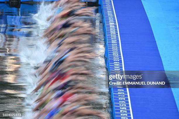 Triathlon athletes start to compete swimming in the Seine river during a Test Event for the women's triathlon for the upcoming 2024 Olympic Games in...