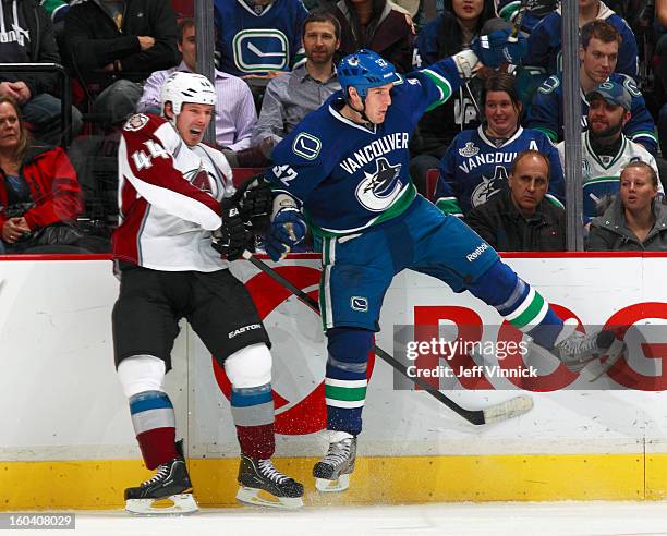 Dale Weise of the Vancouver Canucks collides with Ryan Wilson of the Colorado Avalanche during their NHL game at Rogers Arena January 30, 2013 in...