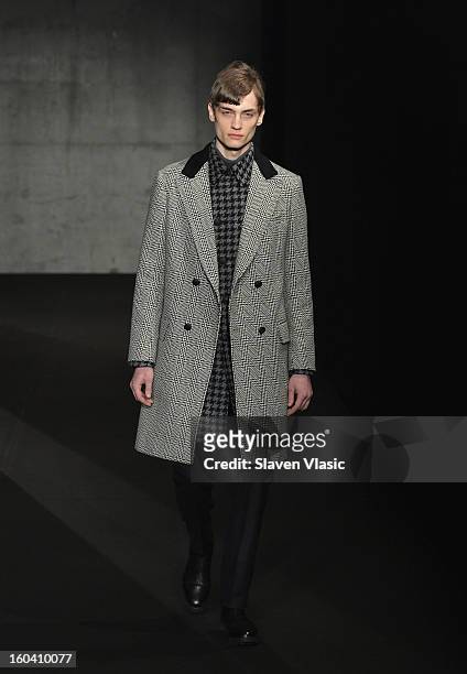 Model walks the runway during the Rag & Bone Men's collection fall 2013 fashion show on January 30, 2013 in New York City.