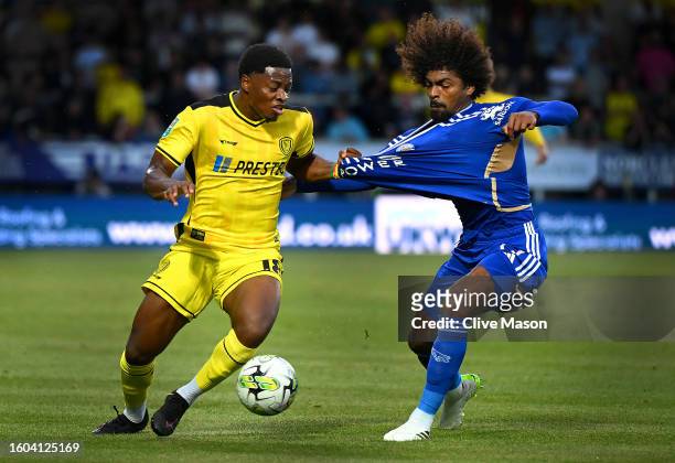 Bobby Kamwa of Burton Albion and Hamza Choudhury of Leicester City battle for possession during the Carabao Cup First Round match between Burton...