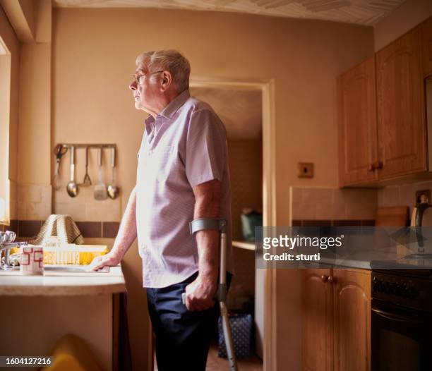 senior daydreaming - loneliness home stock pictures, royalty-free photos & images