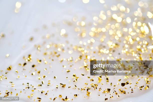 the texture of the serum with 24k golden particles close-up. abstract background. - enzymes cosmetics foto e immagini stock