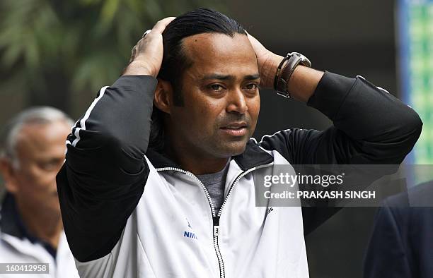 Indian tennis player Leander Paes gestures as he arrives for the draw at the Delhi Lawn Tennis Association tennis court in New Delhi on January 31,...