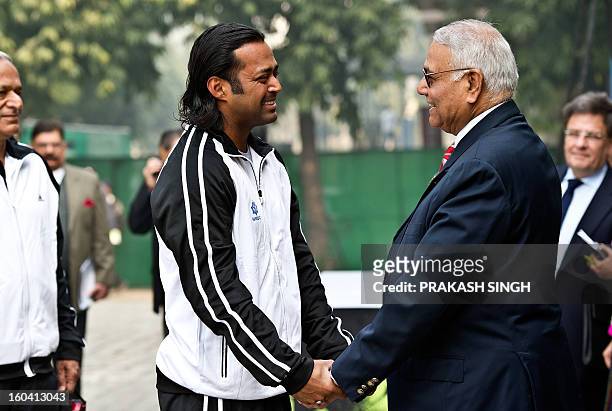 Indian tennis player Leander Paes shakes hands with former All India Tennis Association President Yashwant Sinha prior to the draw at Delhi Lawn...