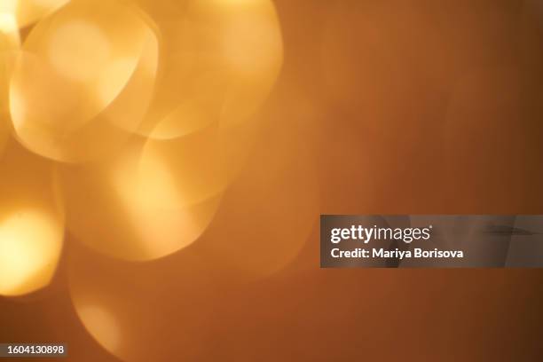 abstract background with golden bokeh. - light bulb stock pictures, royalty-free photos & images