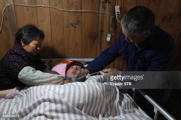 This picture taken on January 28, 2013 shows Fu Xuepeng , a former mechanic who was paralyzed in a This picture taken on January 28, 2013 shows Fu...