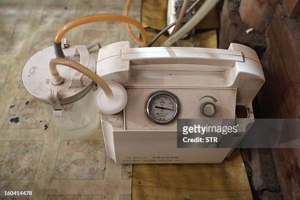 This picture taken on January 28, 2013 shows a self-made ventilator that Fu Xuepeng , a former mechanic who was paralyzed in a road accident when he...