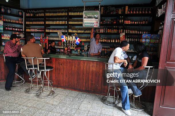 People enjoy a drink in a bar in Santo Domingo on March 4, 2008. Venezuelas President Hugo Chavez and Colombias Alvaro Uribe will attend the Grupo de...