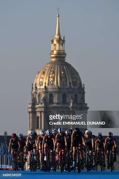 Triathlon athlete ride with the Hotel des Invalides in the background during a Test Event for the women's triathlon for the upcoming 2024 Olympic...