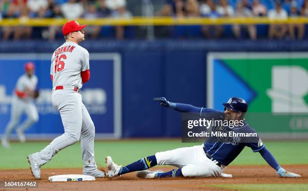 Nolan Gorman of the St. Louis Cardinals turns a double play in the third inning as Josh Lowe of the Tampa Bay Rays slides into second during a game...