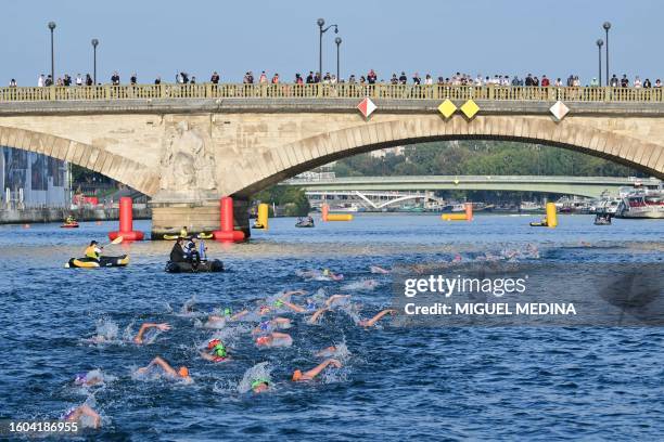 Triathlon athletes compete and swim in the Seine river during a Test Event for the women's triathlon for the upcoming 2024 Olympic Games in Paris, on...