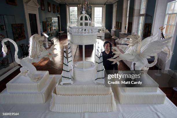 Artist Joan Sallas stands beside a 1.5 metre high folded linen table fountain he is displaying as part of a new exhibition 'Folded Beauty:...