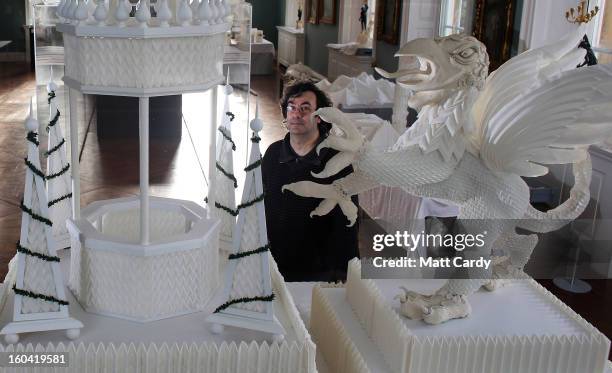 Artist Joan Sallas stands beside a 1.5 metre high folded linen table fountain he is displaying as part of a new exhibition 'Folded Beauty:...