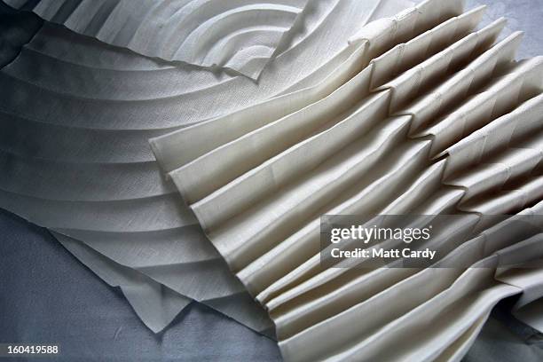 Artist Joan Sallas works on some folded linen pieces he is displaying as part of a new exhibition 'Folded Beauty: Masterpieces in Linen', which is...